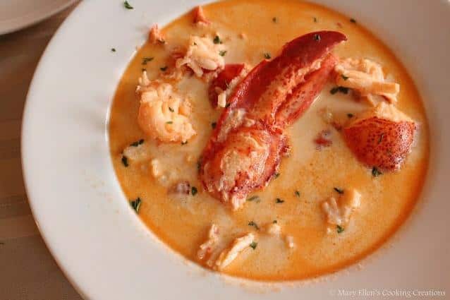  A steaming bowl of hearty seafood stew with chunks of juicy lobster and velvety potatoes.