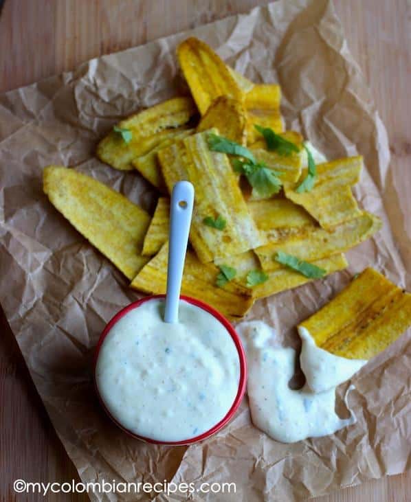  Adorn your plate with golden plantain fries and flavorful salsa de ajo.