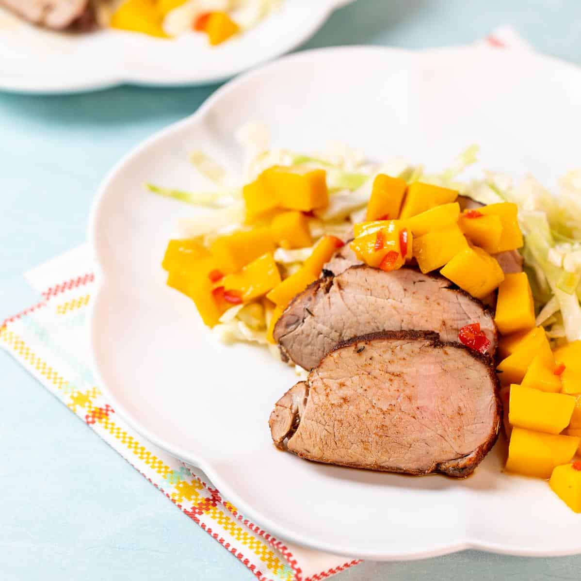  Brighten up your dinner table with these luscious pork medallions adorned with cubes of ripe mango.