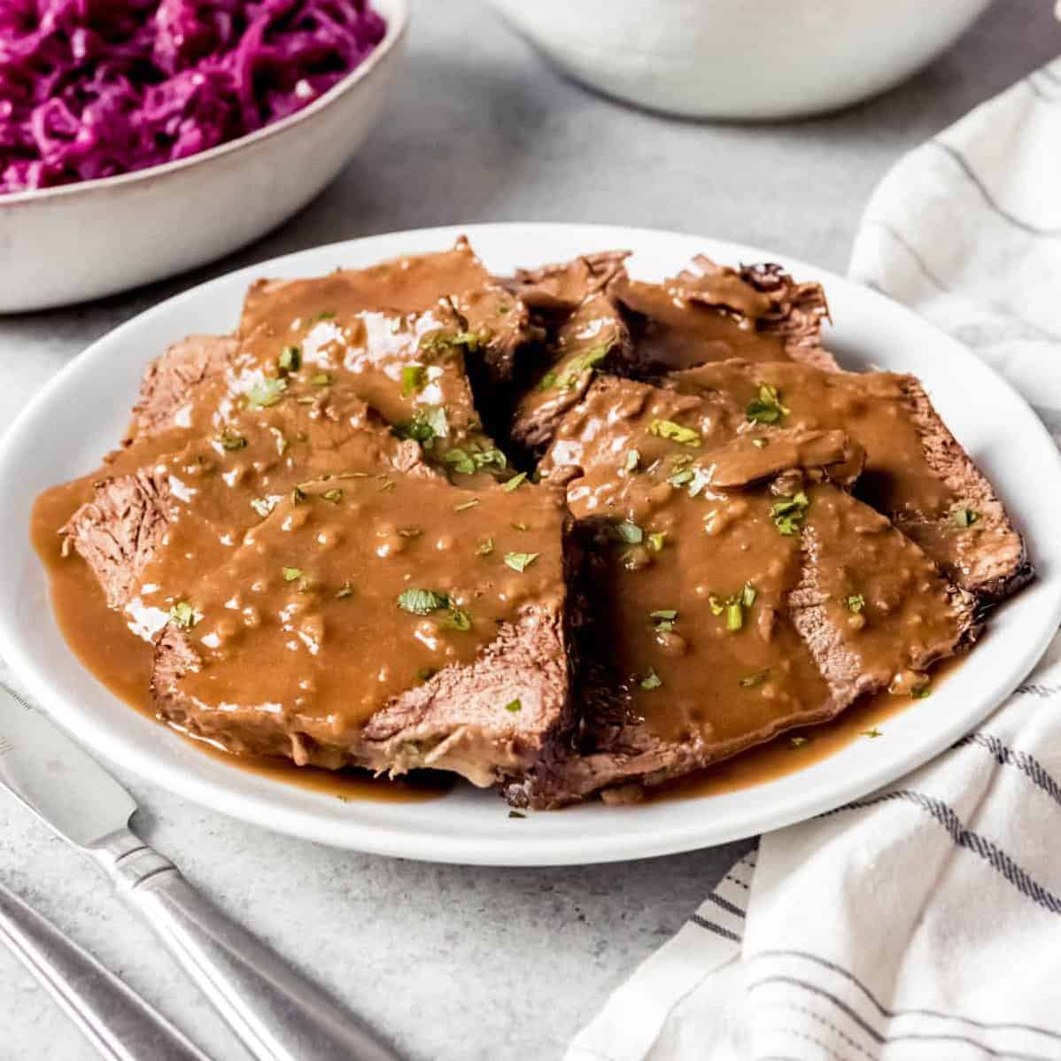  Cut yourself a thick slice of this delicious roast-top round sauerbraten and savor every bite.