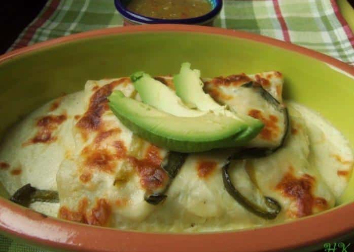  Delicious chicken enchiladas topped with a creamy and tangy jocoque sauce