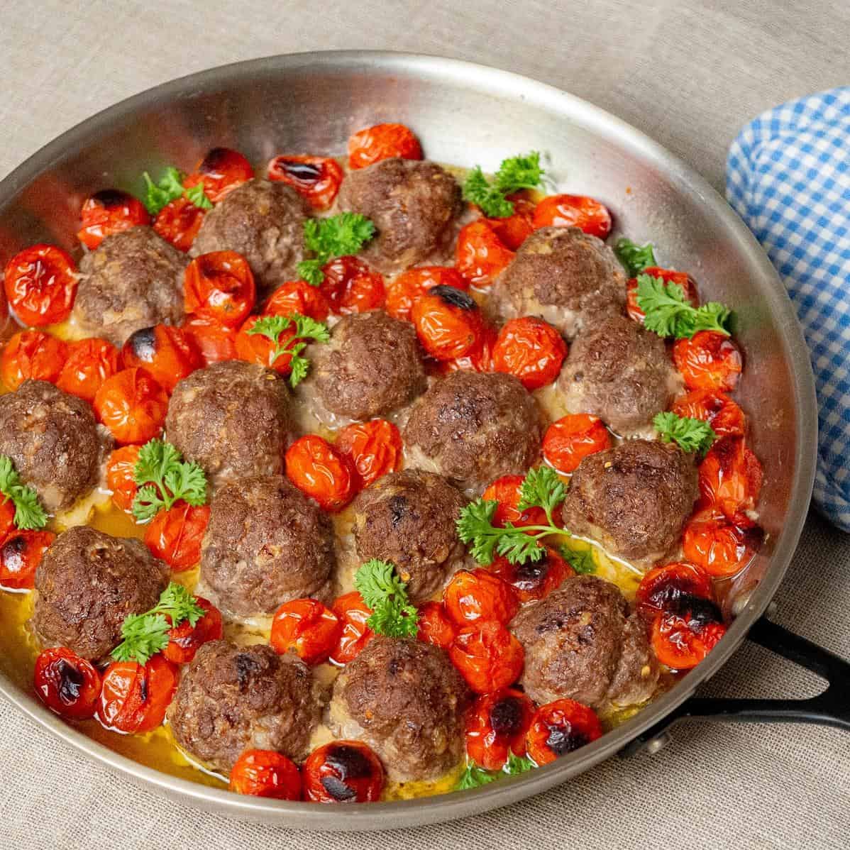  Perfectly seasoned meatballs, flavored with fresh herbs, are combined with juicy cherry tomatoes for a delicious twist on the classic dish.