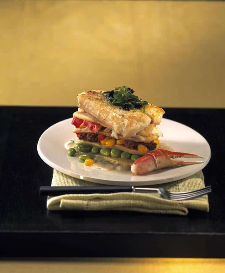  Pristine slices of fresh halibut swim among tender noodles and cheesy layers.