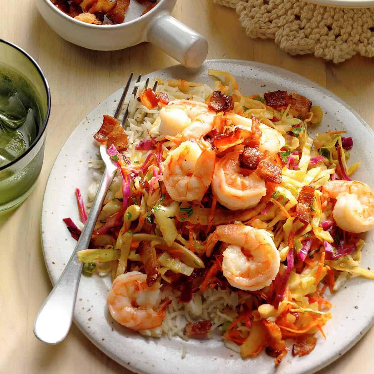  Red cabbage and carrots add a pop of color to the crisp lettuce and juicy shrimp.