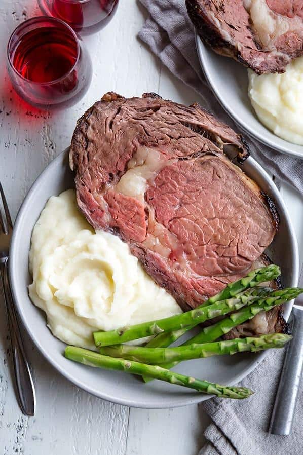  Tender prime rib roast, seasoned with herbs and spices, is the perfect centerpiece for any dinner party.